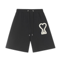 Pantalones cortos Ami Paris shorts negras y blancas con diseño moderno y logo en forma de corazón.
